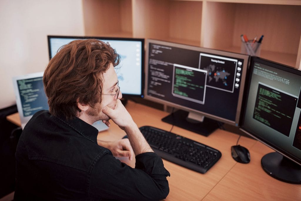 male programmer working on desktop computer